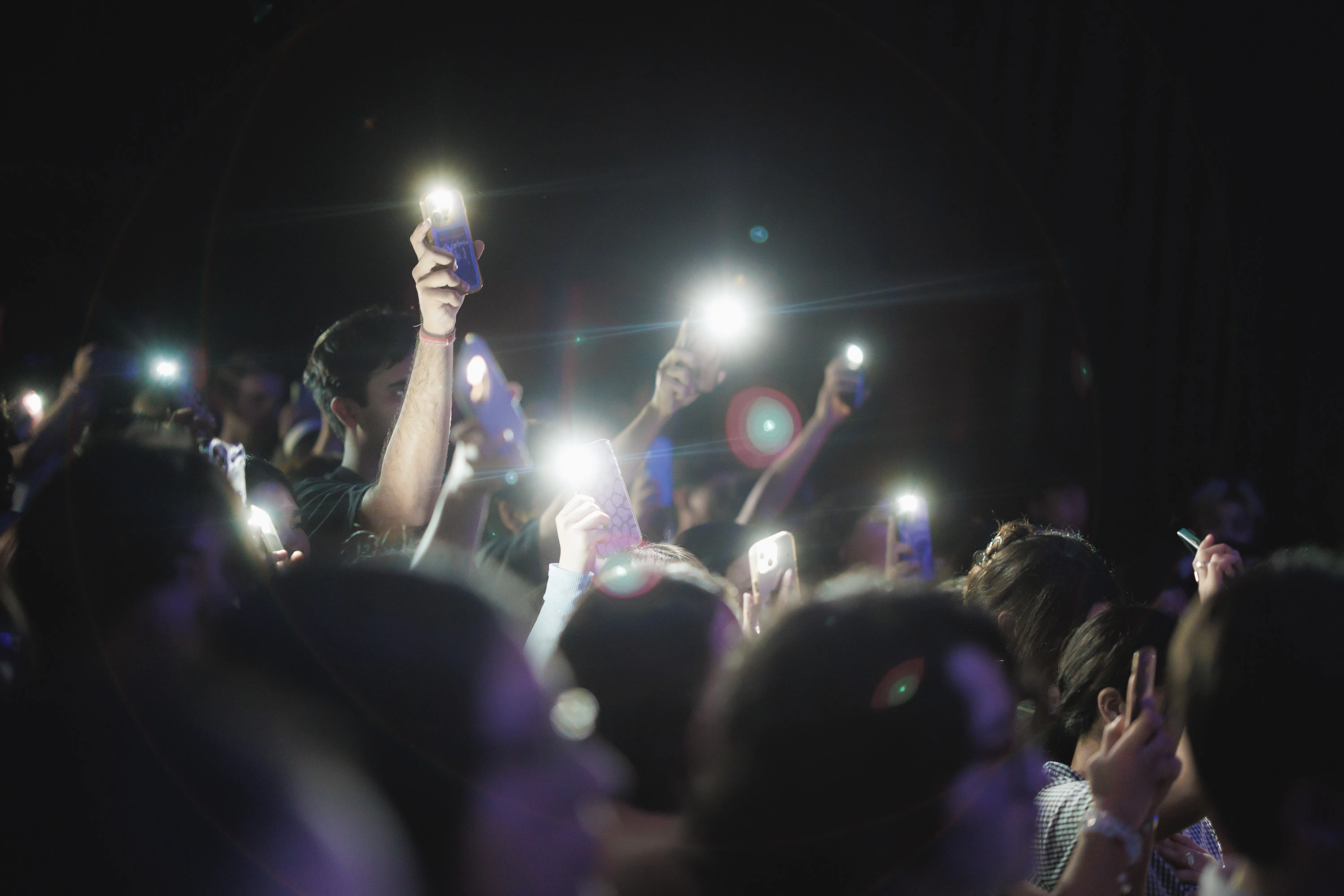 Crowd with flashlights from cell phones